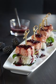 some food is sitting on a white plate with sauce and garnish around it