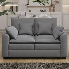 a living room with a gray couch and rug