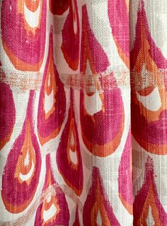 an orange and pink pattern on a curtain