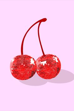 two shiny red cherries on a pink background