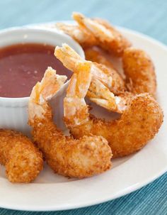 fried shrimp sticks with dipping sauce on a white plate