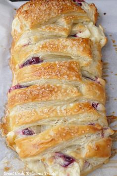 a close up of a pastry with cranberry toppings on it's side