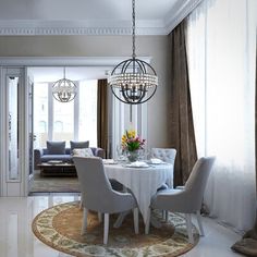 a dining room table with chairs and a chandelier hanging from it's ceiling