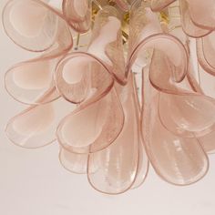 a chandelier with pink glass petals hanging from it's centerpieces