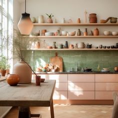 a kitchen filled with lots of different types of pots and pans on the shelves