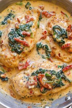 chicken with spinach and tomato sauce in a pan