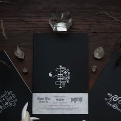 the wedding stationery is black and white with intricate designs on it's cover