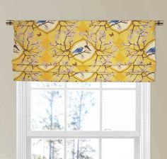 a window with a yellow and blue bird valance hanging from it's side