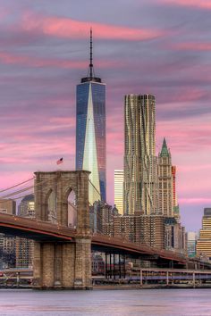 the skyline of new york city is shown at sunset