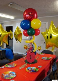 a table with balloons and plates on it