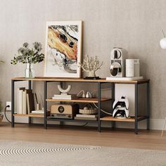 a living room with a shelf and pictures on the wall next to a rug in front of it