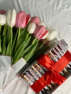 a bouquet of tulips and some candy wrapped in paper