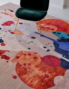 a chair sitting on top of a colorful rug