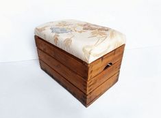 a wooden box with a floral fabric seat cover