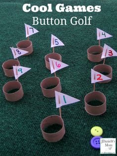 some paper cups are sitting on the ground next to small flags and numbers that have been placed in them