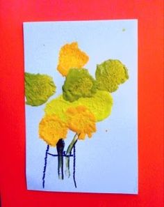 an art project with yellow flowers in a vase on a red background, and the image is made out of colored crayon paper