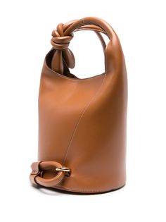 Find JACQUEMUS Le Petit Tourni Leather Bucket Bag on Editorialist. Caramelo brown Made from smooth leather Circular top handle Knotted shoulder strap Logo lettering at front Press-stud fastening Metal feet Main compartment Canvas lining with zip pocket Gold-tone hardware Made in Italy Bags 2024, Origami Fashion, Simply Fashion, Bucket Handbags, Soft Bag, Recycle Bag, Mini Bucket Bags, Trendy Tote Bags, Bucket Bags