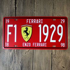 a ferrari license plate is hanging on a wooden wall