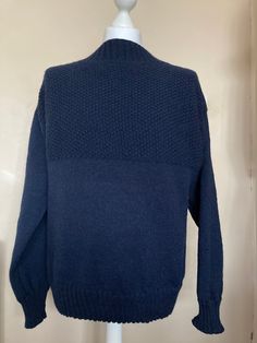 a blue sweater on a mannequin head