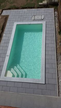 an above ground swimming pool in the middle of a yard with steps leading up to it