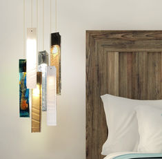 a bed with white pillows and wooden headboard next to a wall mounted light fixture