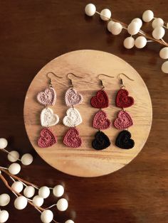 crocheted heart earrings on a wooden table