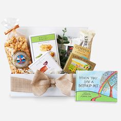 a gift basket filled with books, snacks and other items for someone's special occasion