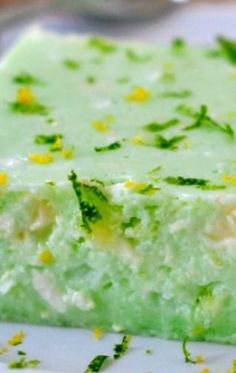 a close up of a piece of cake on a plate with green and yellow decorations