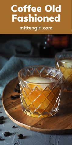 two glasses filled with coffee on top of a wooden tray