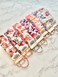 several key chains with different designs on them