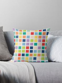 a colorful throw pillow sitting on top of a couch