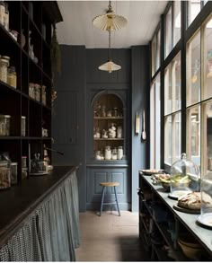 an empty kitchen with lots of counter space and open shelves on the wall behind it