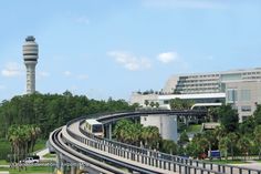 a train traveling down tracks next to a tall tower