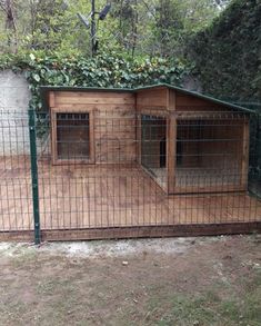 the dog house is made out of wood and has two doors on each side, with one door open