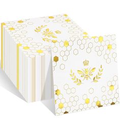 two white and yellow boxes with gold designs on the sides, one is folded up