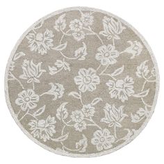 a round rug with white flowers on it