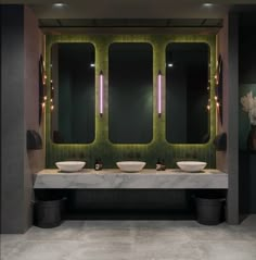 a bathroom with two sinks and three mirrors