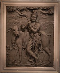 an image of the god and cow on display in a frame