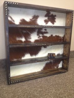 a cowhide display case on the floor