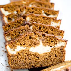 slices of cake sitting on top of each other next to another piece of bread that is cut in half