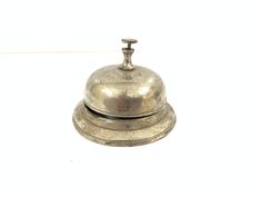 an old silver bell on a white background