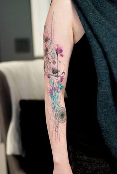 a woman with a flower tattoo on her arm