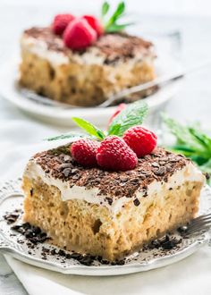 two pieces of cake with raspberries on top