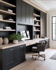 a home office with built in bookcases and desk