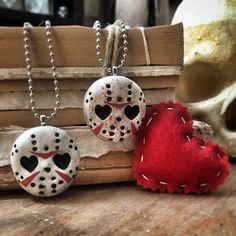 two necklaces that have been made to look like they are in the shape of hockey masks