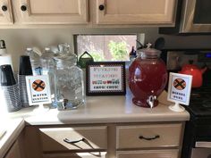 a kitchen counter topped with jars filled with liquid