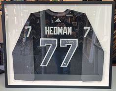 a hockey jersey is displayed in a glass case with the number 777 printed on it