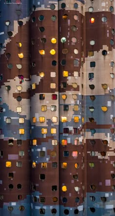 the side of a building with many holes in it