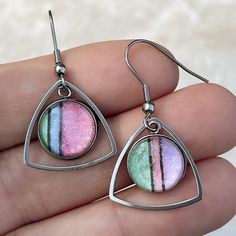 a pair of earrings with different colors on them