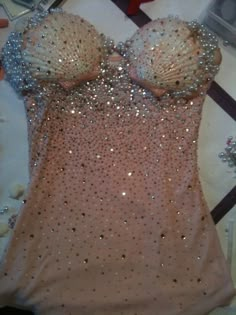 a dress with sequins on it laying on a table